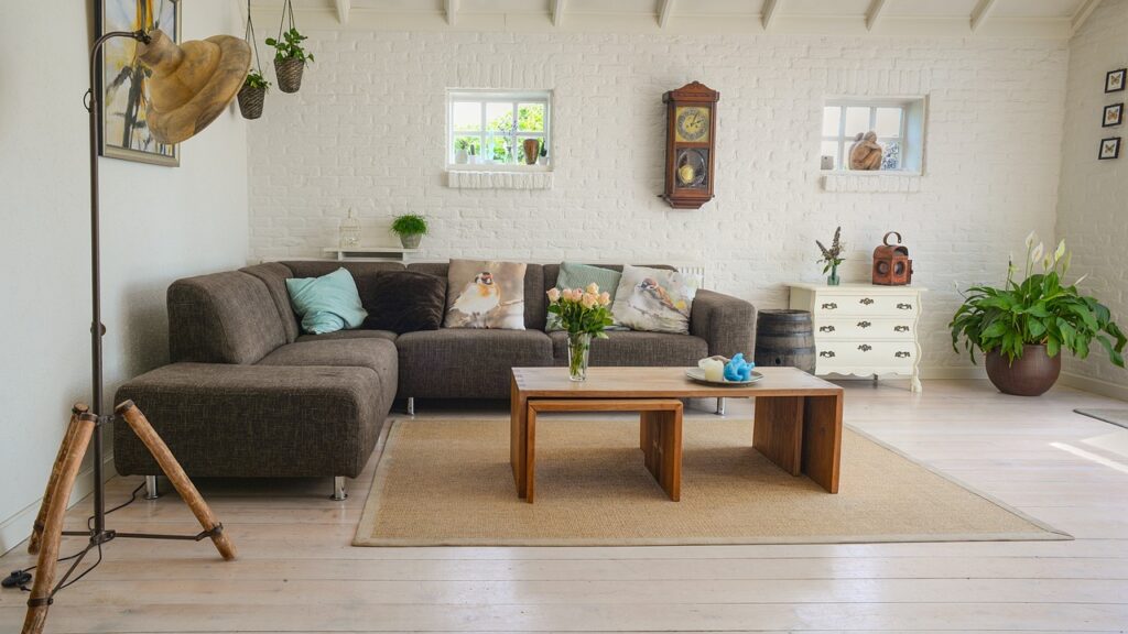 cozy interior with white times and white walls, grey furniture with wood tables